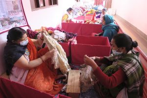 Photo: MyPad: Workers sorting through discarded clothing to create biodegradable cloth pads.
